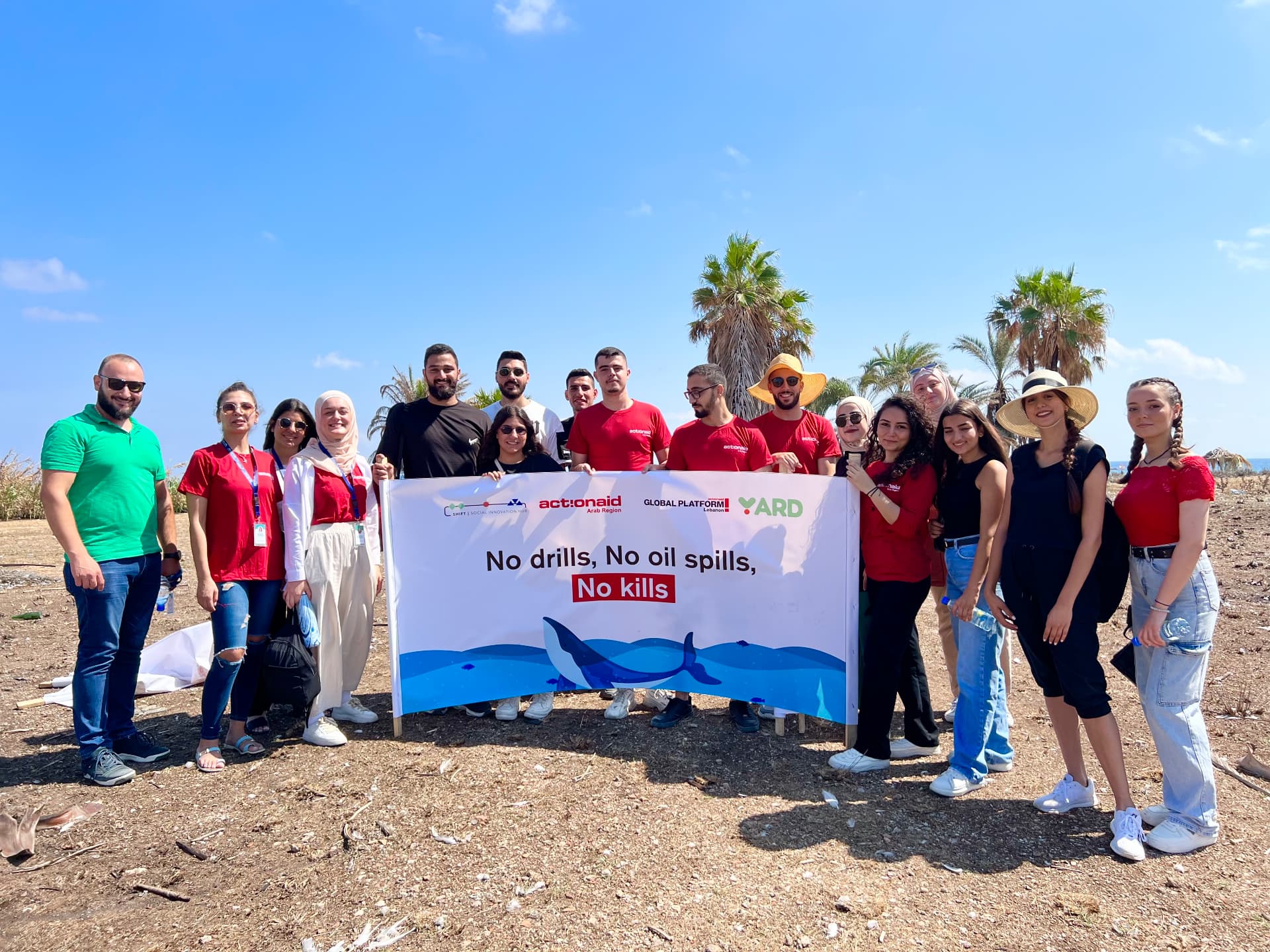 YARD and ActionAid youth on the Tripoli shore holding a No drills, No oil spills, No kills banner.