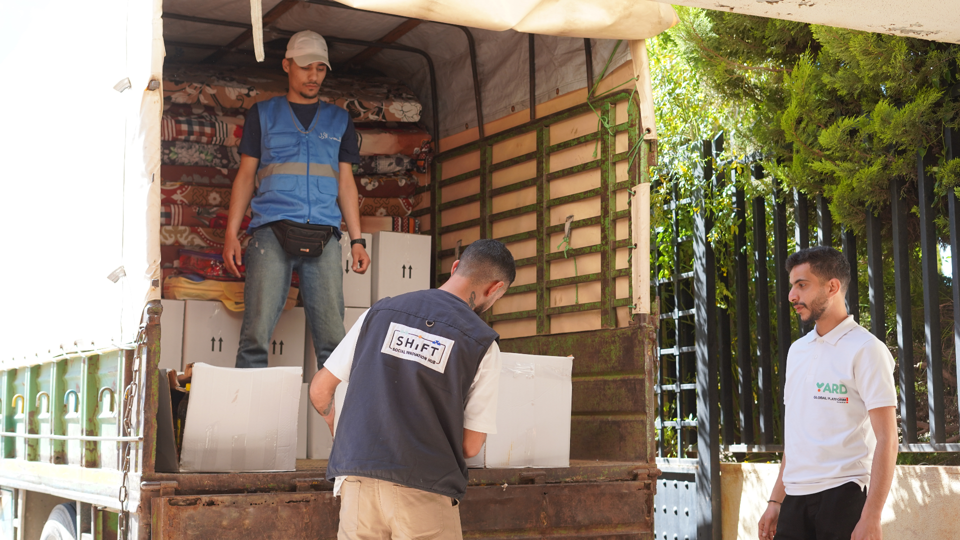 YARD and SHiFT volunteers loading relief boxes and supplies into a truck for displaced families.